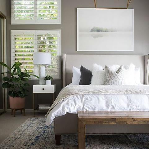 A bedroom painted with Benjamin Moore Graystone, paint color available at Clement's Paint in Austin, Texas.