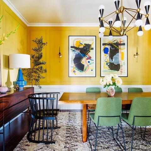 A dining room with half of the wall painted with Benjamin Moore's Yolk, paint color available at Clement's Paint in Austin, Texas.