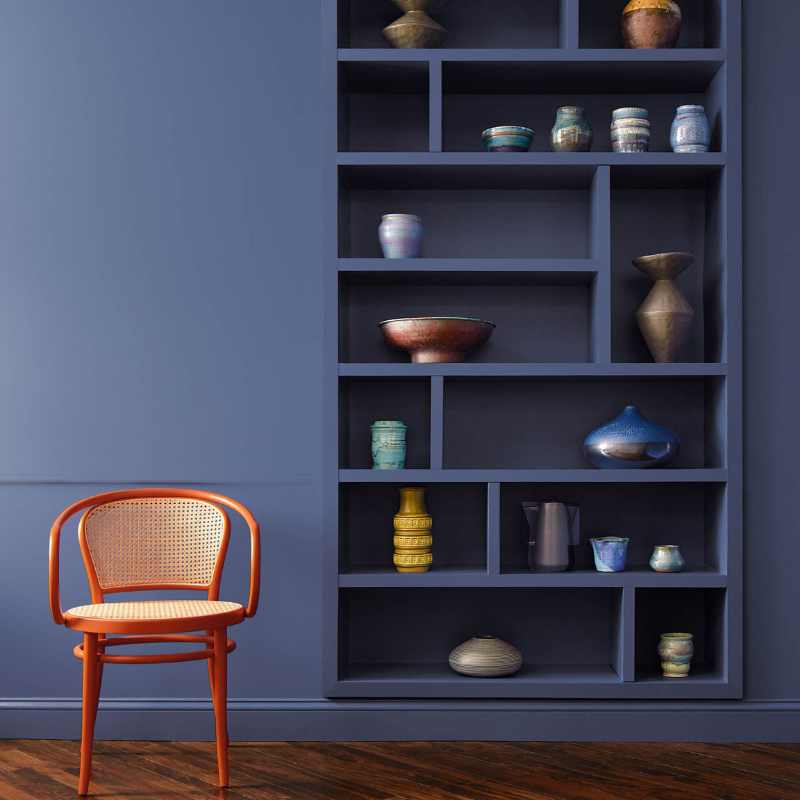 Benjamin Moore's Blue Nova paint color used on a wall with a red chair