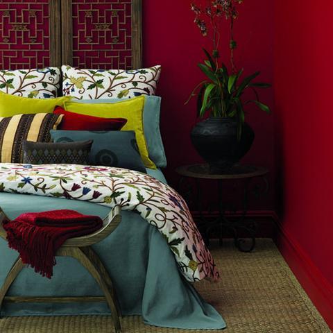 A bedroom painted with Benjamin Moore's Caliente, paint color available at Clement's Paint in Austin, Texas.