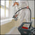 A man using a titan paint sprayer in a home, available at Clement's Paint in Austin, TX.